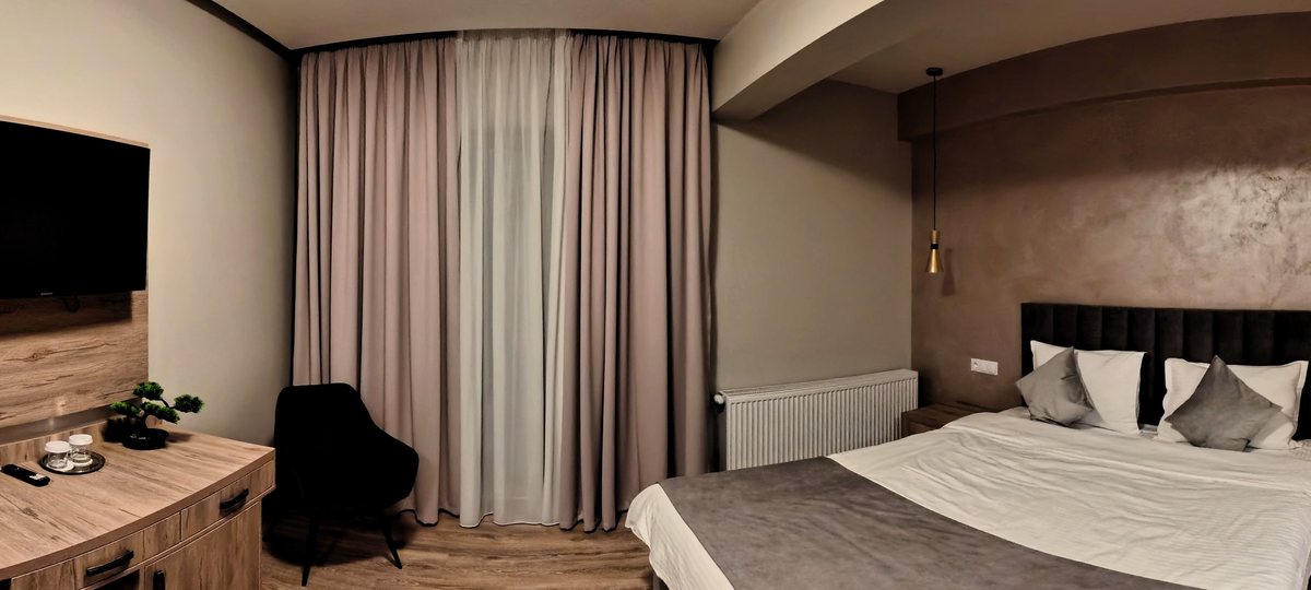 Bright double room with soft drapes and valley light
