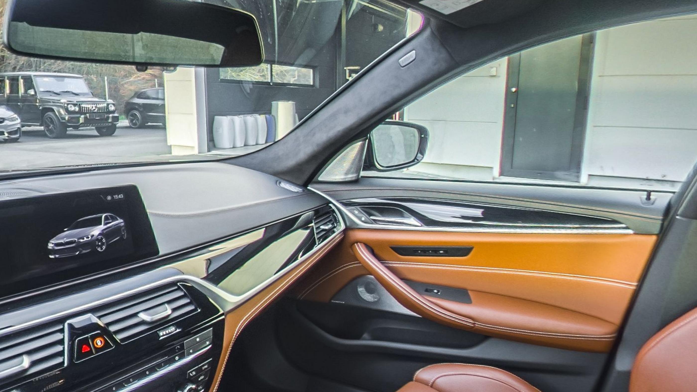 The dashboard and passenger door card in cognac leather with stitched trim