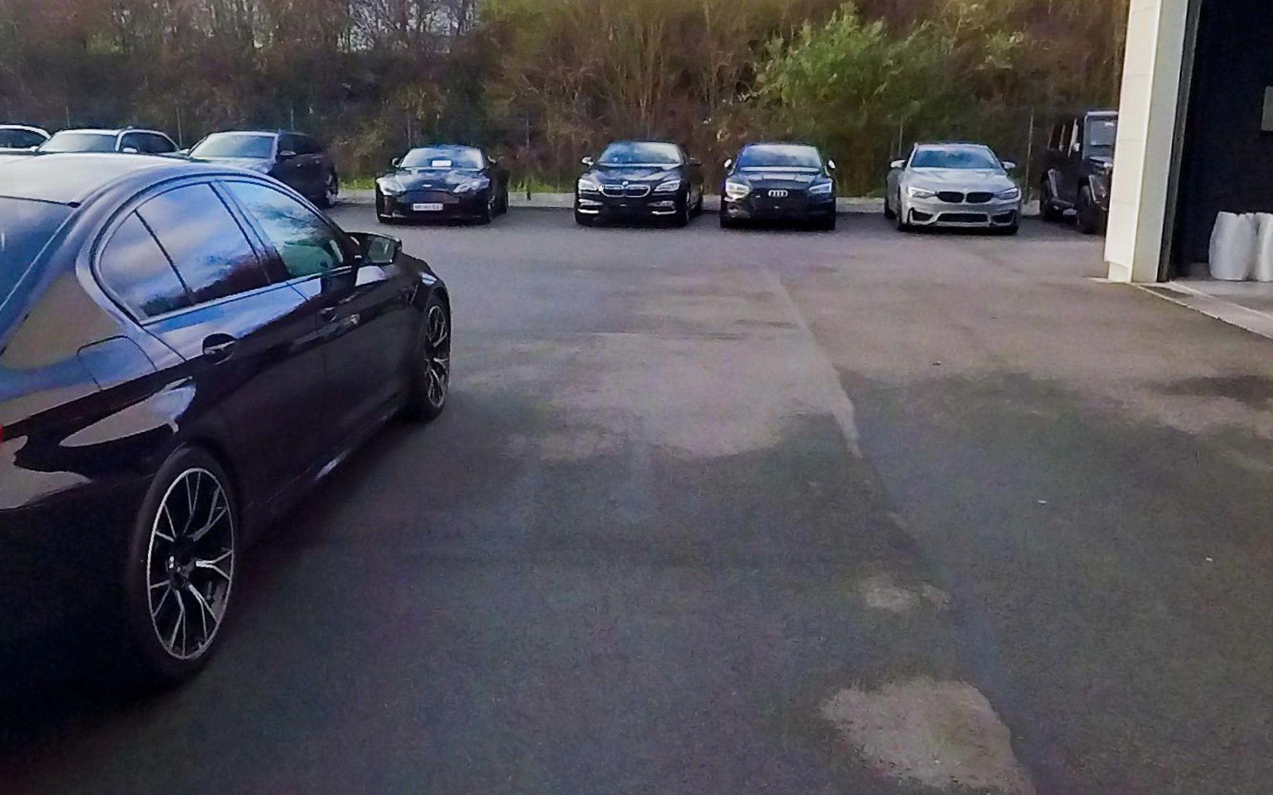 The car from the rear quarter, boot lid and rear wheel