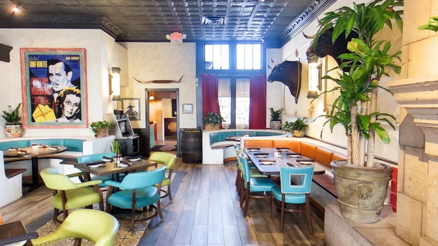A large pop art portrait beside teal chairs