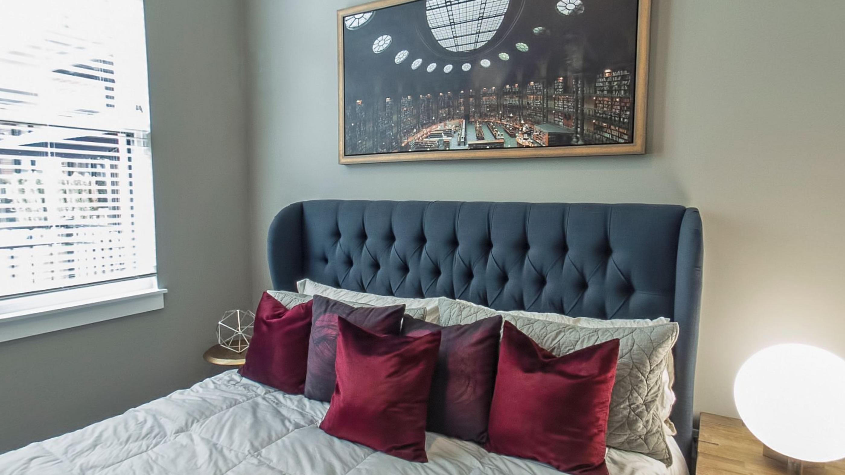 A bedroom with a padded headboard
