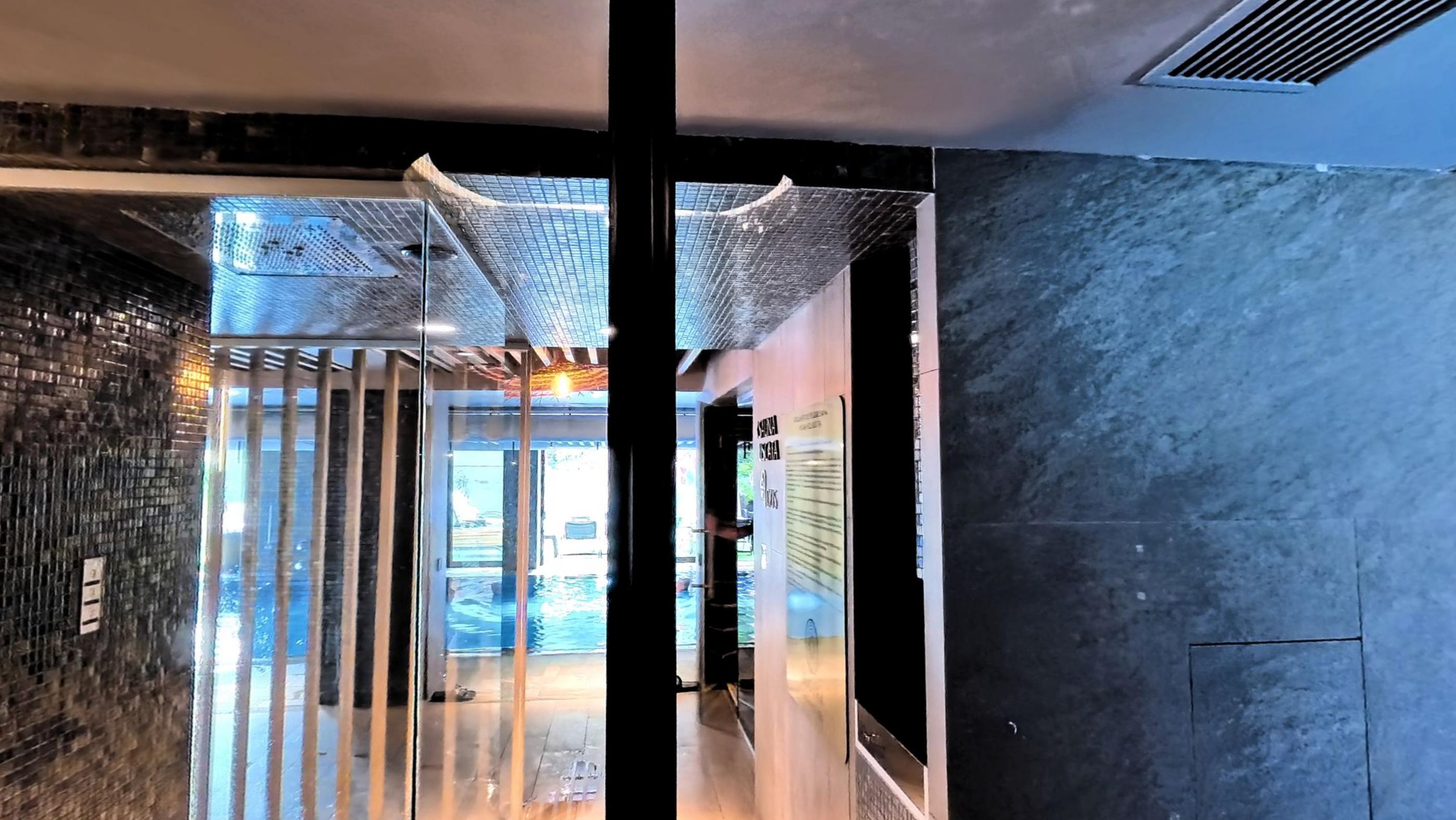 A dark mosaic tiled steam room