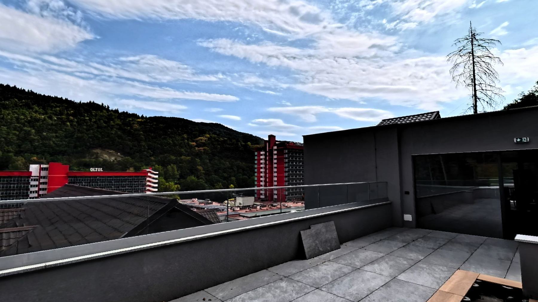 The rooftop terrace looking over the trees to the hills