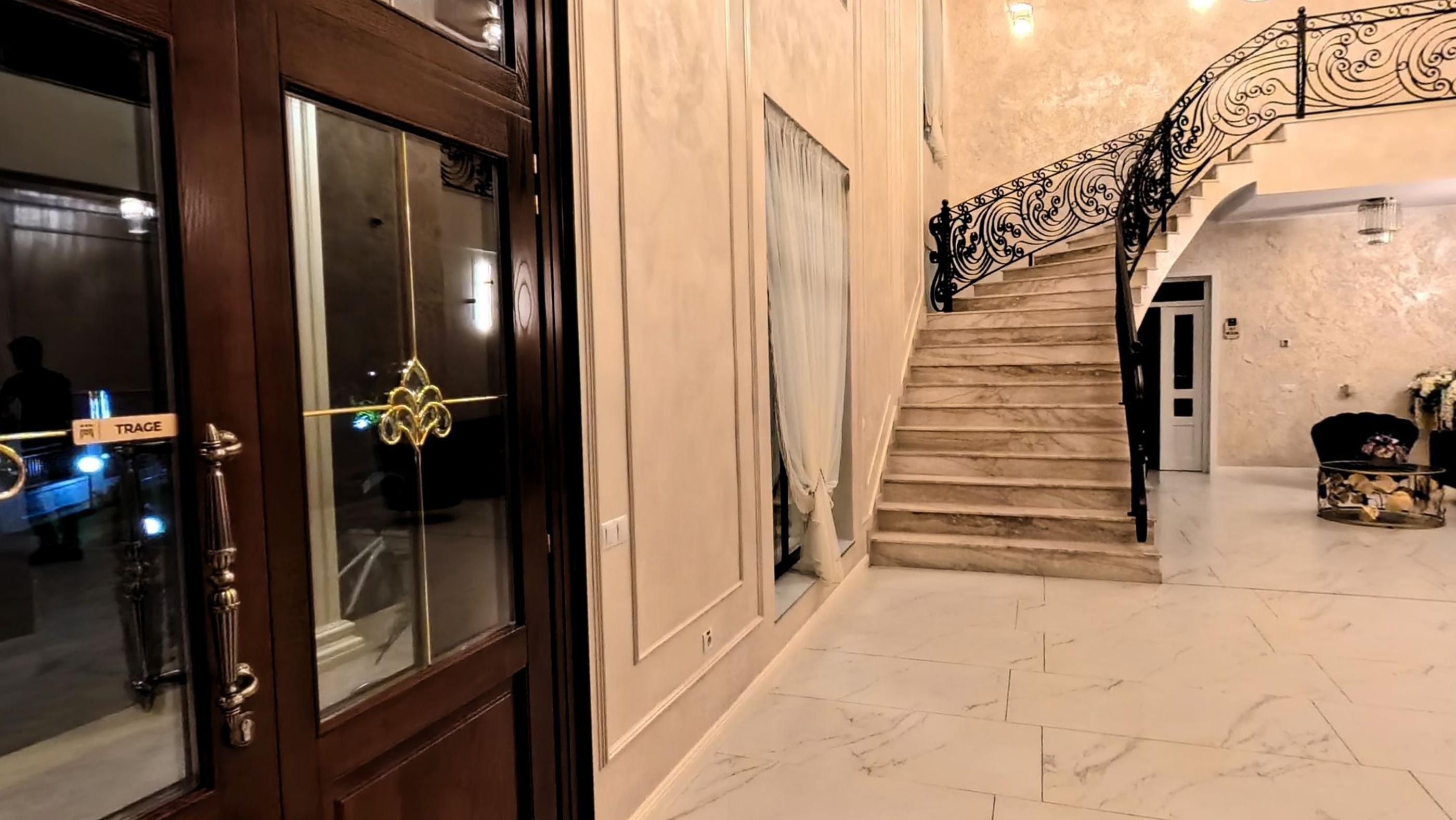 A double marble staircase curving up from the hotel lobby