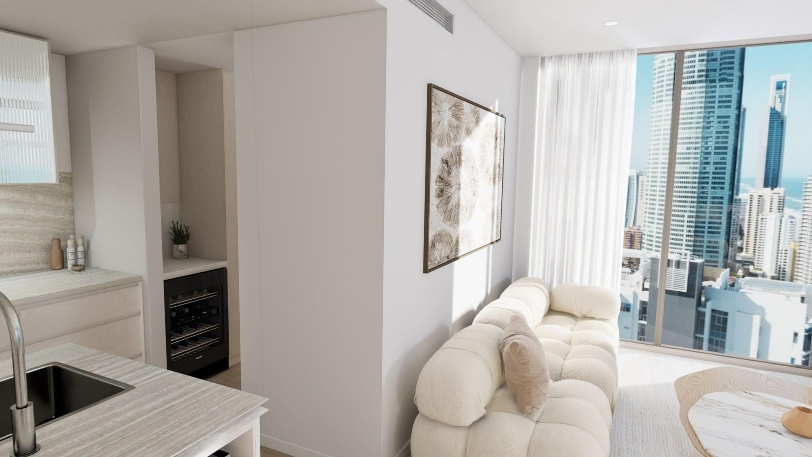 A white living room with a deep sofa and floor to ceiling glazing onto city towers