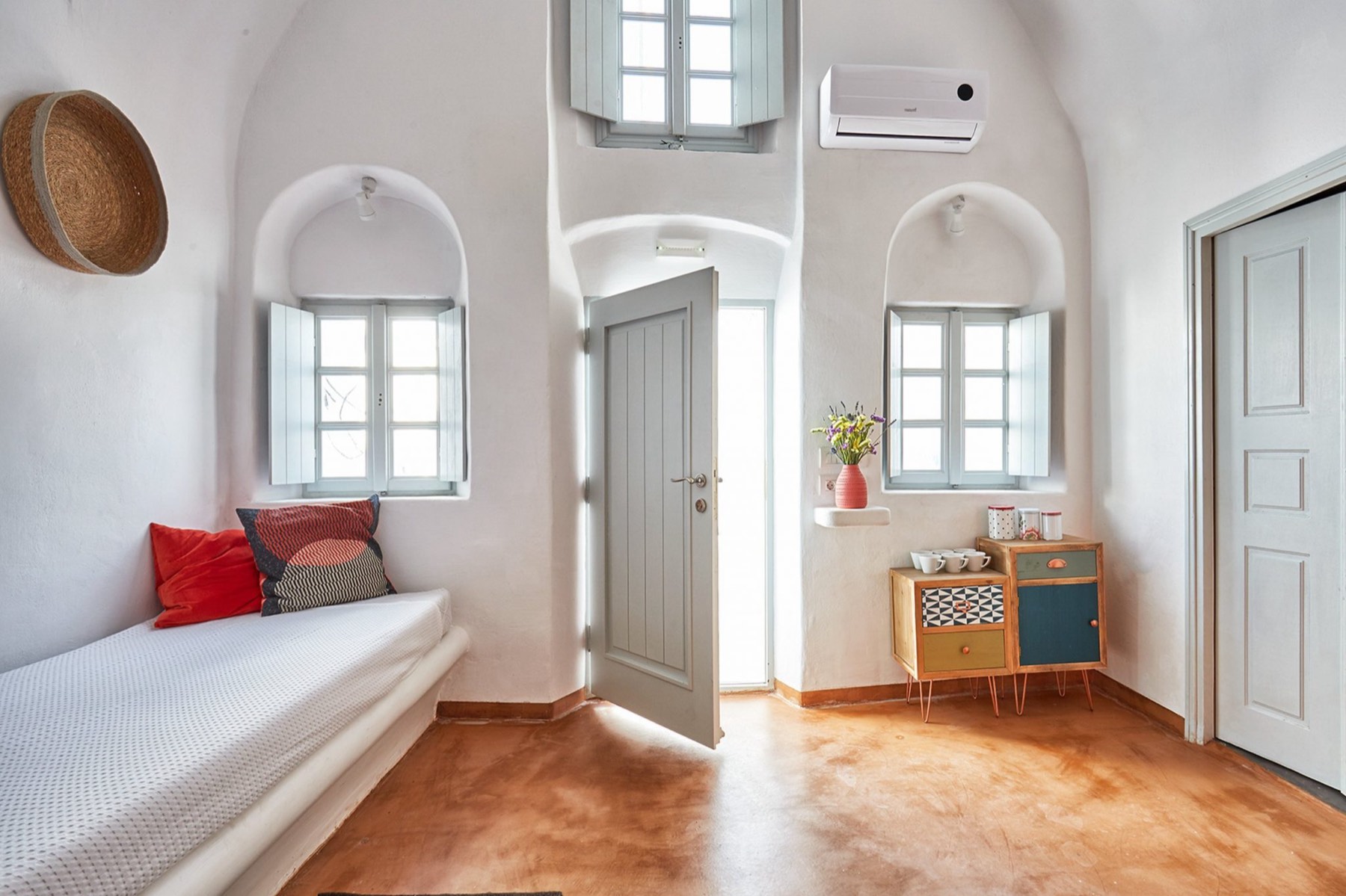 Arched alcove windows above a built-in bed