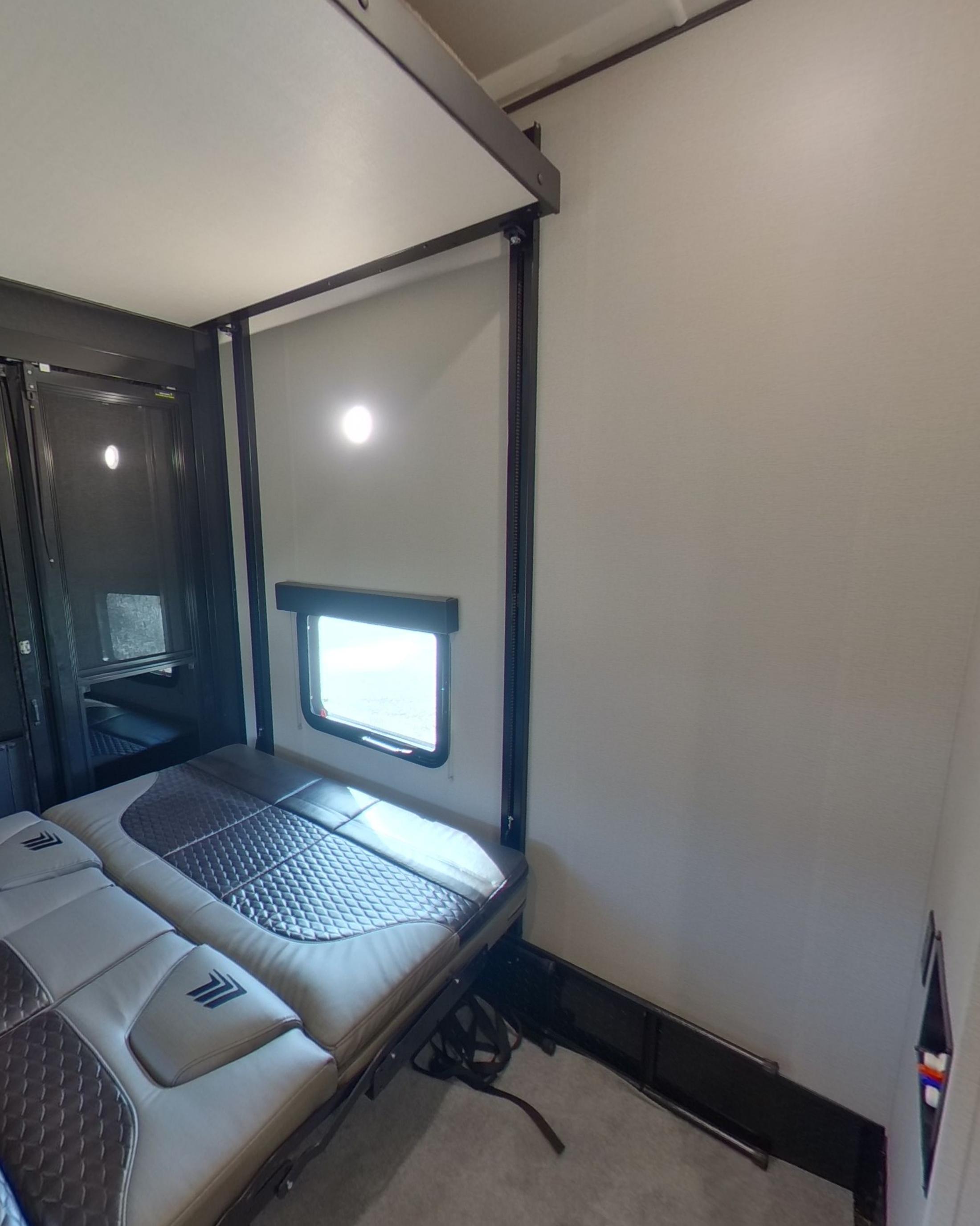The rear garage with a bench that folds down into a bed